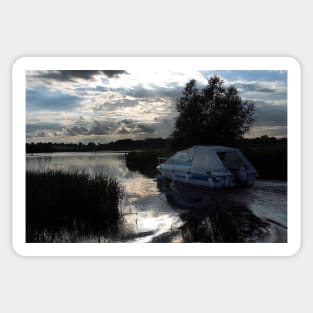 A boat travelling the Norfolk Broads near dusk Sticker